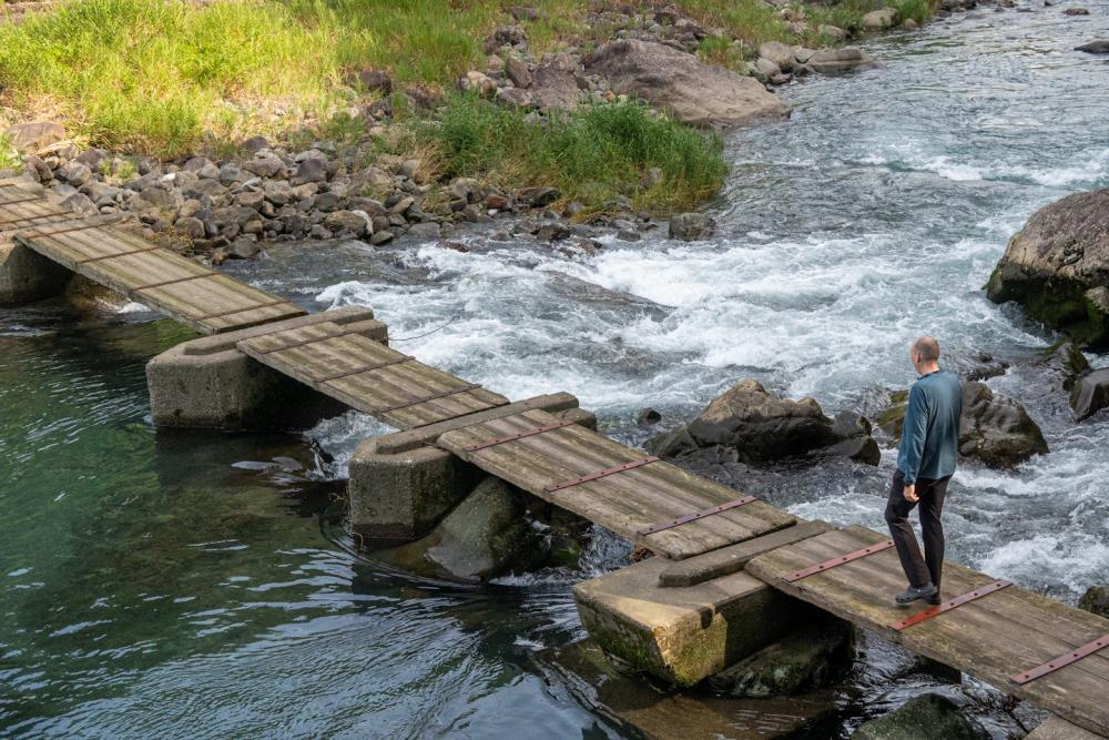 Cross the wooden bridge over the Katsuuragawa River to the camping facity called Pangaea Field